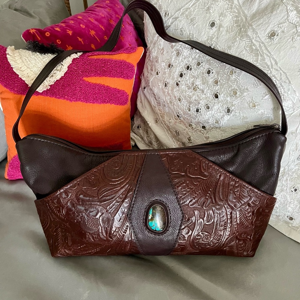 Handmade handbag with tooled leather details and turquoise center stone